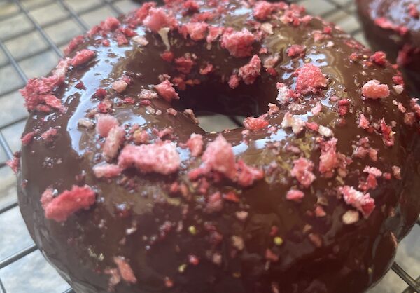 Chocolate strawberry glaze donuts closeup